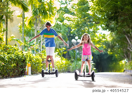 Child on hover board. Kids riding scooter 40554527