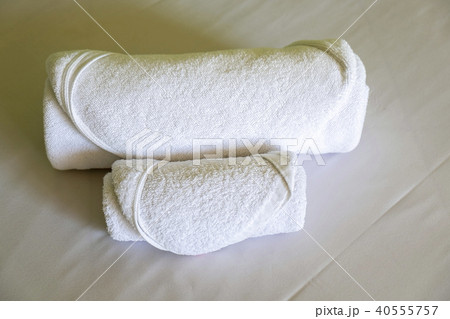 Hotel Towels Roll on the White bed in the Bedroom 40555757