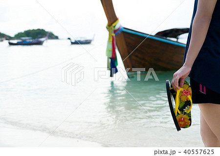 girl hold slipper walking on white sand relax time girl hold slipper walking on white sand relax time 40557625