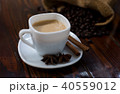 Coffee in a white cup on a wooden table. 40559012