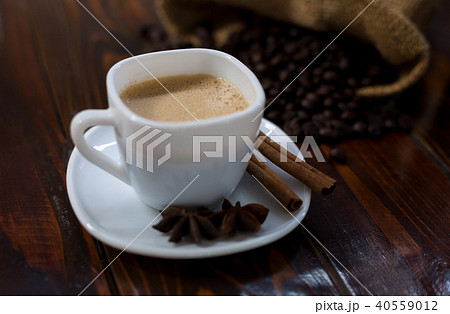 Coffee in a white cup on a wooden table. 40559012