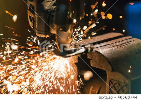 Metal grinder with sparkles in workshop 40560744
