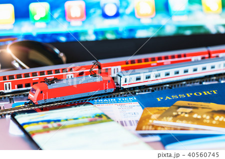 Toy train, tickets, passport and bank card on laptop or notebook 40560745