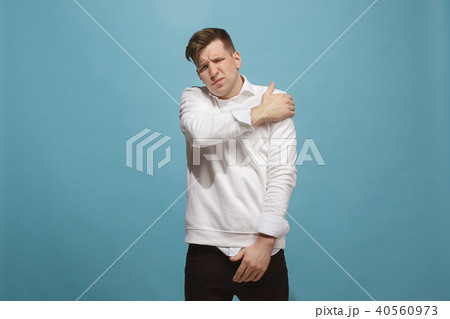 Young man overwhelmed with a pain in the shoulder 40560973