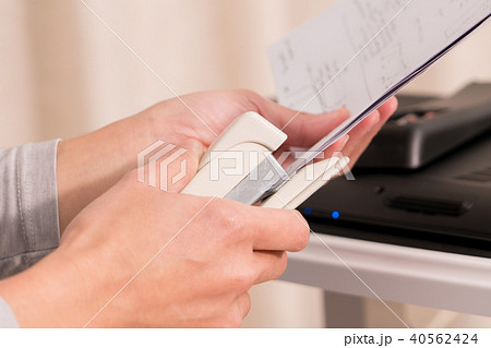 women hand stapling hand writing paper 40562424