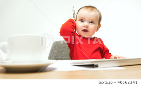 Happy child baby girl toddler sitting with keyboard of computer isolated on a white background 40563341