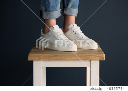 Girl in white fashionable sneakers Girl in white fashionable sneakers 40565754