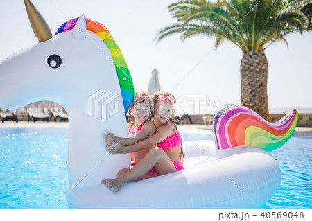 Two little kids playing in the swimming pool Two little kids playing in the swimming pool 40569048