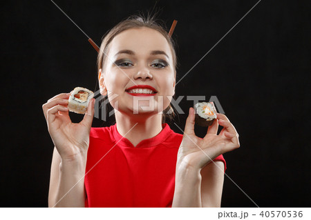 woman with sushi rolls 40570536