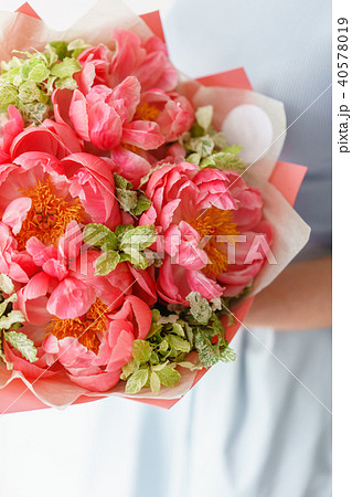 Lovely flowers in glass vase. Beautiful bouquet of peonies sort of coral charm. Floral composition 40578019