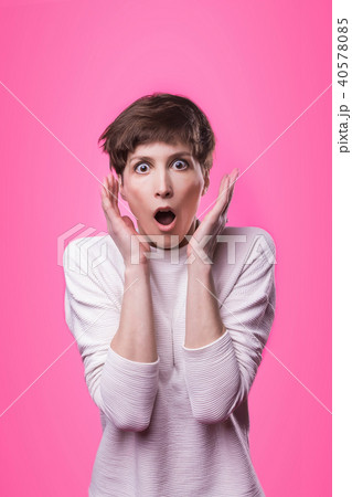 Wow. Beautiful female half-length front portrait isolated on pink studio backgroud. 40578085