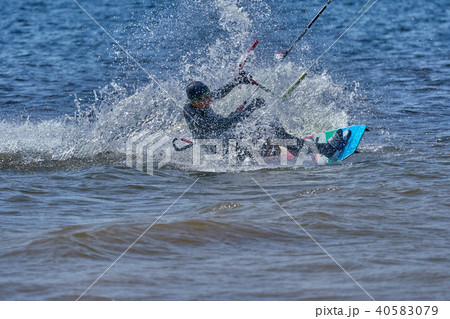 male kiteboarder rides on a board on a large river male kiteboarder rides on a board on a large river 40583079