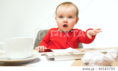 Happy child baby girl toddler sitting with keyboard of computer isolated on a white background Happy child baby girl toddler sitting with keyboard of computer isolated on a white background 40583793