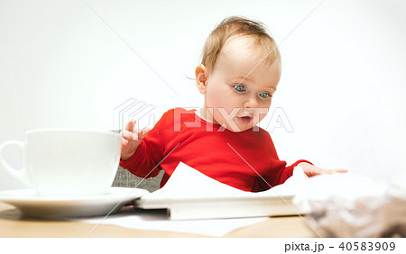 Happy child baby girl toddler sitting with keyboard of computer isolated on a white background Happy child baby girl toddler sitting with keyboard of computer isolated on a white background 40583909