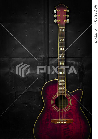 Purple acoustic guitar over dark background Purple acoustic guitar over dark background 40585396