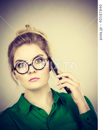 Focused business woman talking on phone Focused business woman talking on phone 40587840