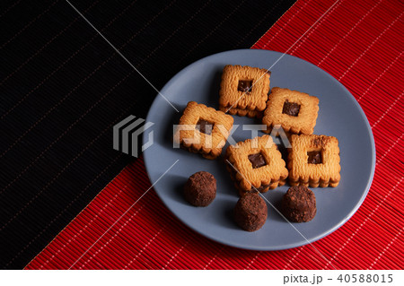 Chocolate sand chip cookies stacked up on a plate 40588015