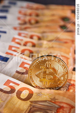 Golden bitcoin on fifty euro banknotes background Golden bitcoin on fifty euro banknotes background 40588016