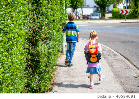 Little girls walking away with her filled backpack 40594091