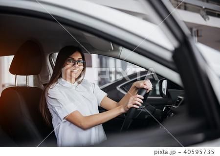 portrait of young beautiful woman sitting in the car 40595735