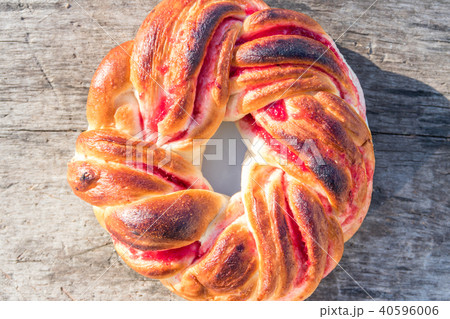 Sweet bun with jam on wooden table Sweet bun with jam on wooden table 40596006