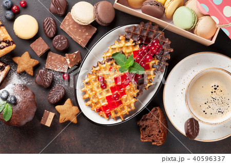 Coffee, sweets and waffles with berries 40596337