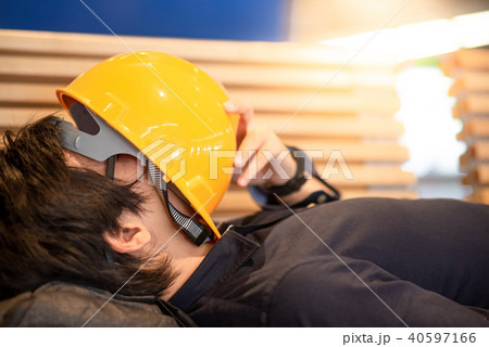 Asian engineer man lying on bench feeling tried 40597166