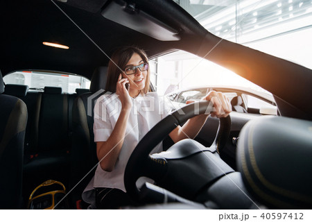 Businesswoman talking on the phone in the car 40597412
