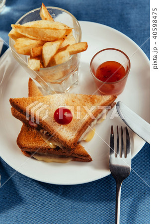 Grilled cheese sandwich and fries. 40598475