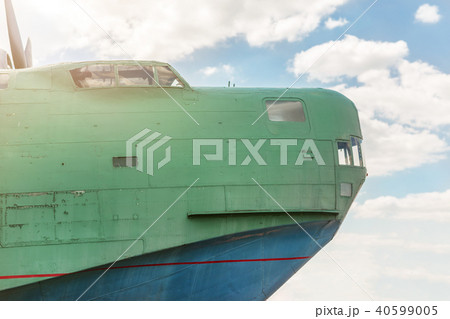 Front part of old amhibian plane against blue sky. Vintage anti-submarine military hydroplane Front part of old amhibian plane against blue sky. Vintage anti-submarine military hydroplane 40599005