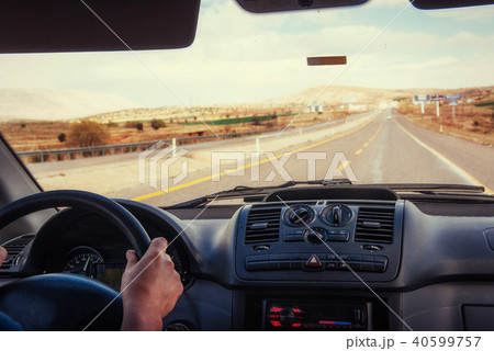 Driver's hands on steering wheel of a car 40599757