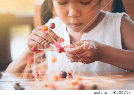 asian child girl play and creating with play dough 40609710