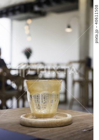 Finished drink of latte coffee on wooden saucer 40611508