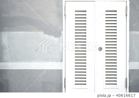 Locked white entrance door on painted cement wall 40616617