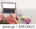 Pregnant woman is shopping online with laptop. 40616621