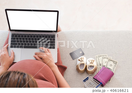 Pregnant woman is shopping online with laptop. 40616621