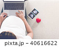 Pregnant woman is shopping online with laptop. 40616622