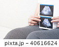 Blurry of happy pregnant woman holding ultrasound. 40616624