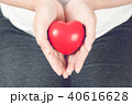 Red heart on pregnant woman hand. 40616628