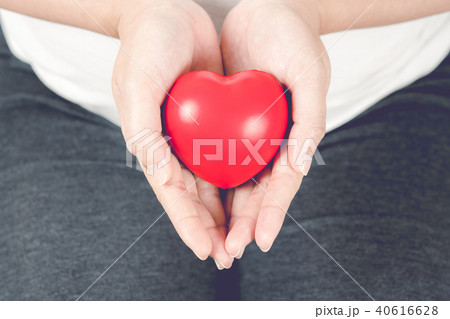 Red heart on pregnant woman hand. 40616628