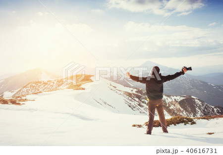 tourist looks at the landscape. Photographer on top of mountain tourist looks at the landscape. Photographer on top of mountain 40616731