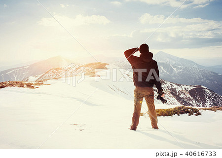 tourist looks at the landscape. Photographer on top of mountain tourist looks at the landscape. Photographer on top of mountain 40616733