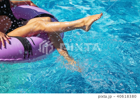 girls feet playing with water in the pool 40618380