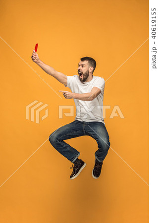 Football supporter with red card on orange background 40619155