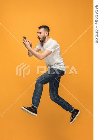 Full length of handsome young man taking selfie while jumping 40619196