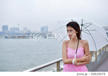 Holiday concept. Beautiful girl is holding umbrella on the beach Holiday concept. Beautiful girl is holding umbrella on the beach 40620076