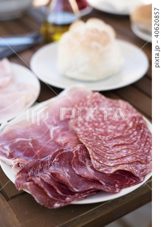 plate with different cold cuts on a table 40620857