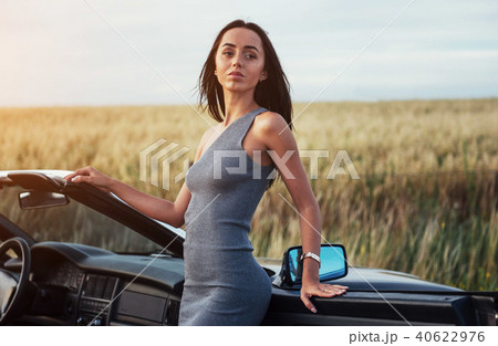 Beautiful woman near black convertible Beautiful woman near black convertible 40622976
