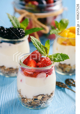Natural yogurt with muesli, mango and berries. Natural yogurt with muesli, mango and berries. 40627526