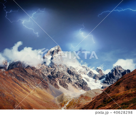 Fantastic collage. Beautiful lightning over the snow-capped moun 40628298